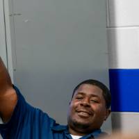 student raising his fist and smiling